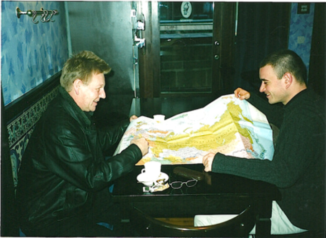 Ron Peck and collaborator Grégory Maillot pore over a map of Russia before making their first work trip there under NESTA sponsorship.